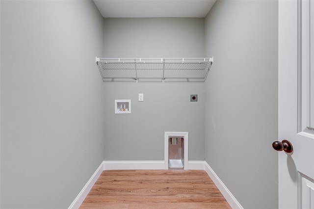 washroom with hookup for a washing machine, light hardwood / wood-style floors, and electric dryer hookup