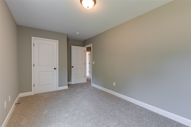 unfurnished bedroom featuring a closet and carpet flooring