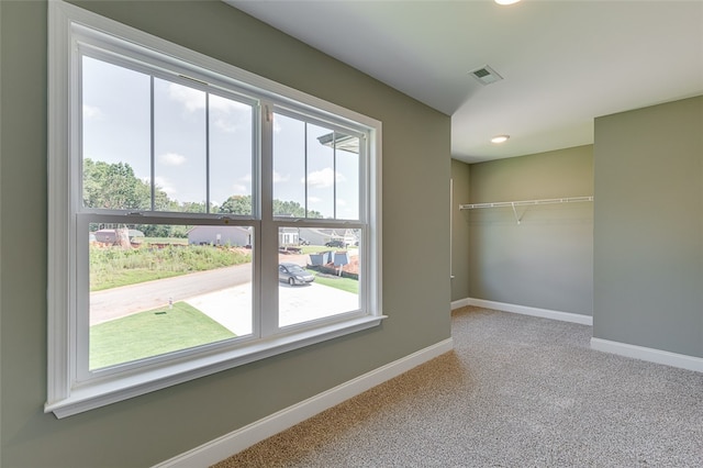 spare room featuring light carpet