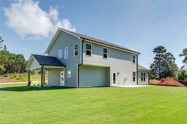 rear view of property featuring a lawn and a patio