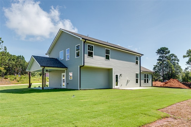 rear view of house with a lawn and a patio area