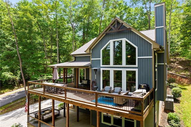 back of property featuring cooling unit, outdoor lounge area, and a wooden deck