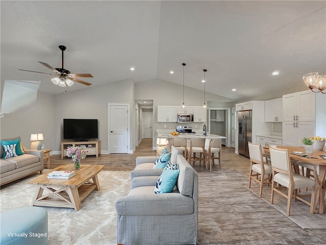 living room with ceiling fan, sink, and vaulted ceiling