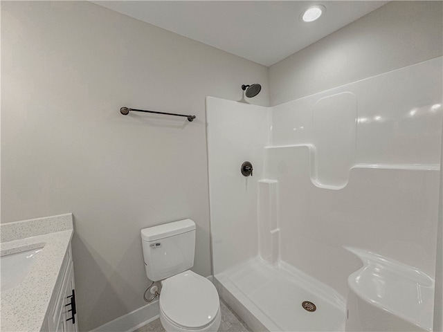 bathroom featuring walk in shower, vanity, and toilet