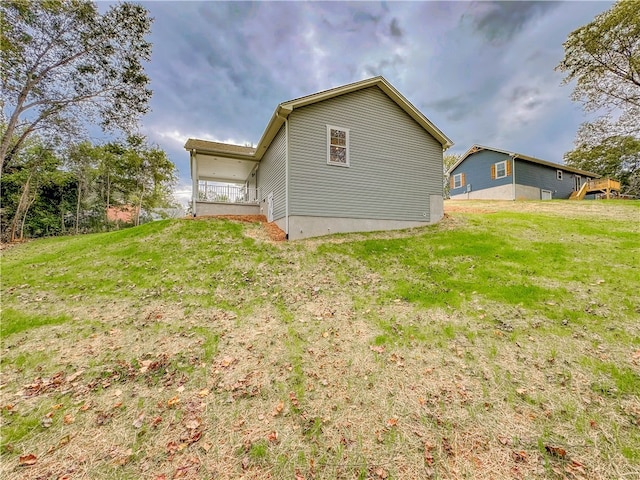 view of property exterior with a yard