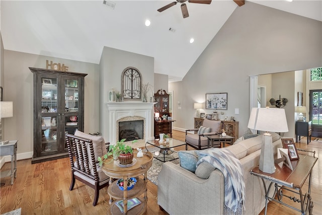 living room with high vaulted ceiling, light wood-type flooring, and ceiling fan