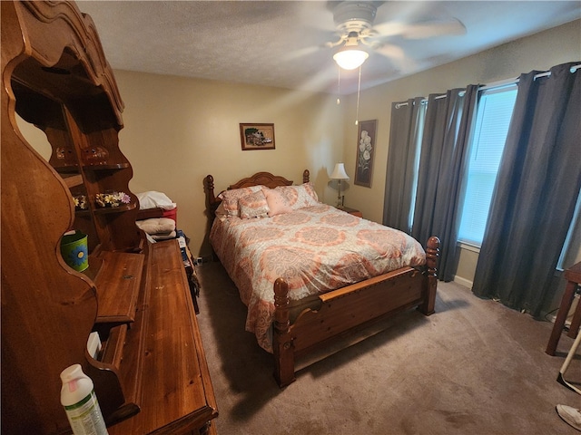 bedroom with ceiling fan and light colored carpet