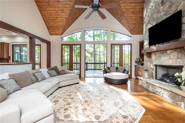 living room with a healthy amount of sunlight, wood ceiling, and high vaulted ceiling