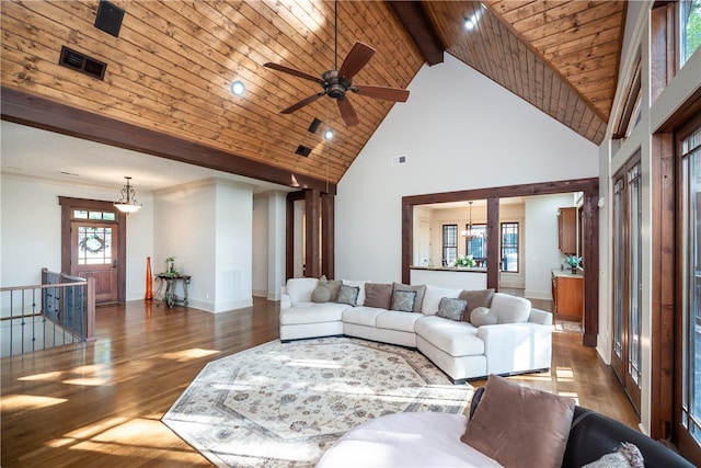 living room featuring hardwood / wood-style floors, high vaulted ceiling, and plenty of natural light