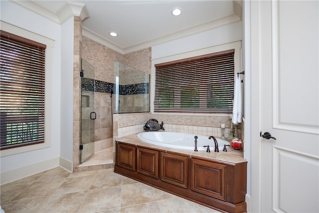 bathroom featuring separate shower and tub and ornamental molding