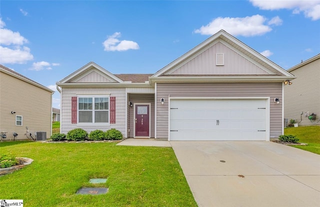 view of front of property featuring cooling unit, a garage, and a front lawn