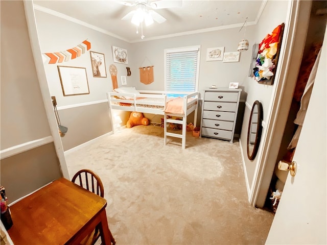 carpeted bedroom with ceiling fan and ornamental molding