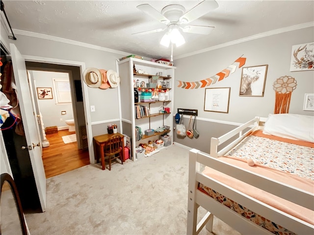 bedroom featuring crown molding, light carpet, and ceiling fan