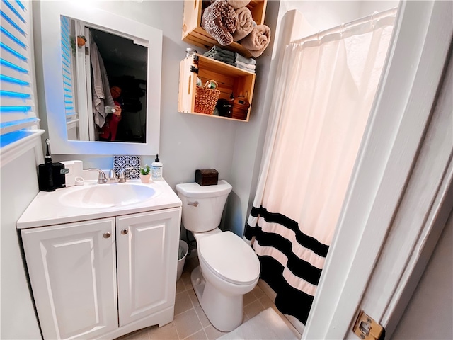 bathroom featuring curtained shower, vanity, toilet, and tile patterned floors