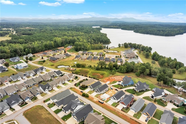 drone / aerial view with a water and mountain view