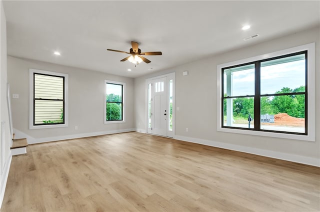 unfurnished living room with ceiling fan and light hardwood / wood-style flooring