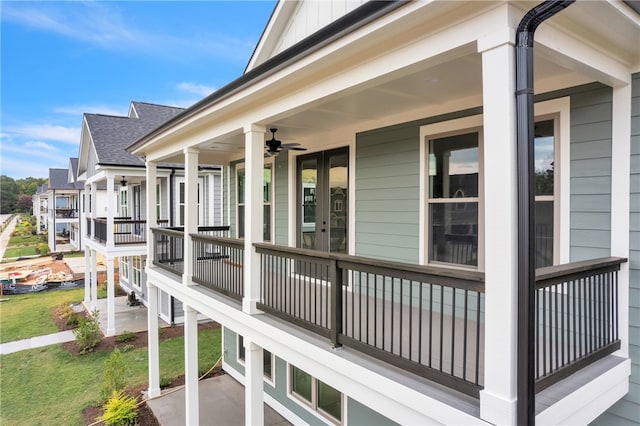 wooden deck with ceiling fan and a yard