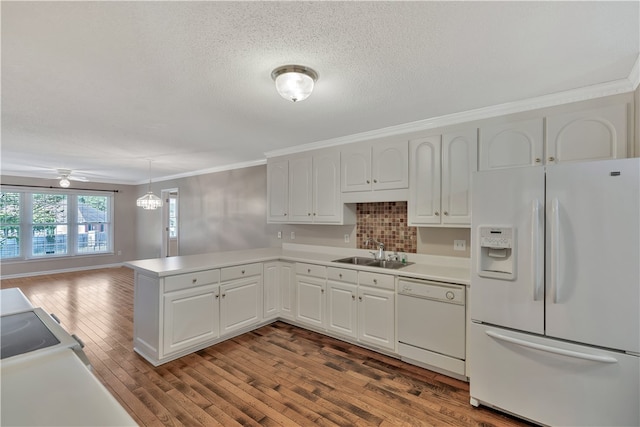 kitchen with white cabinetry, white appliances, kitchen peninsula, pendant lighting, and wood-type flooring