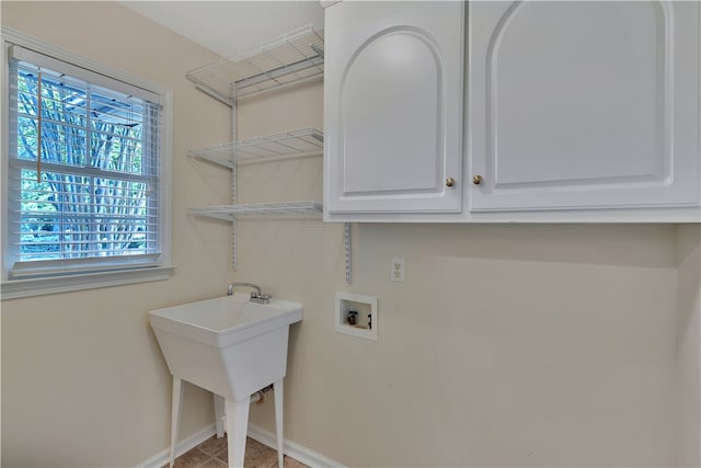 laundry room with hookup for a washing machine and cabinets