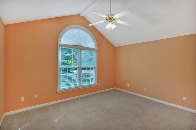 carpeted spare room with ceiling fan and vaulted ceiling with beams