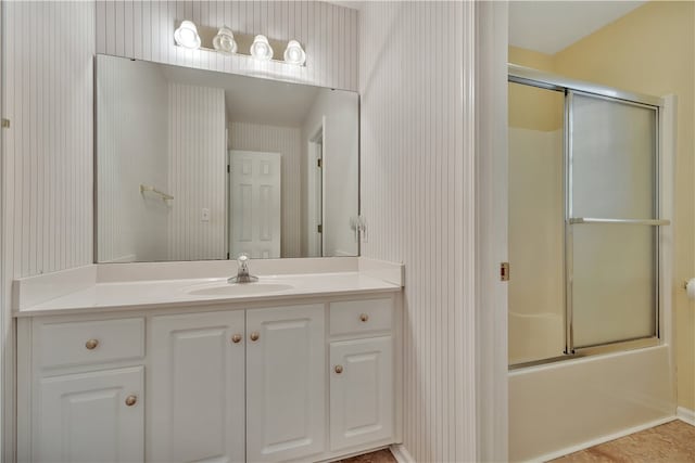 bathroom with vanity and combined bath / shower with glass door