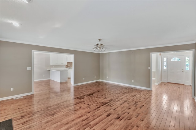 unfurnished living room with ornamental molding, light wood-type flooring, and ceiling fan