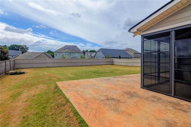 view of yard featuring a sunroom and a patio