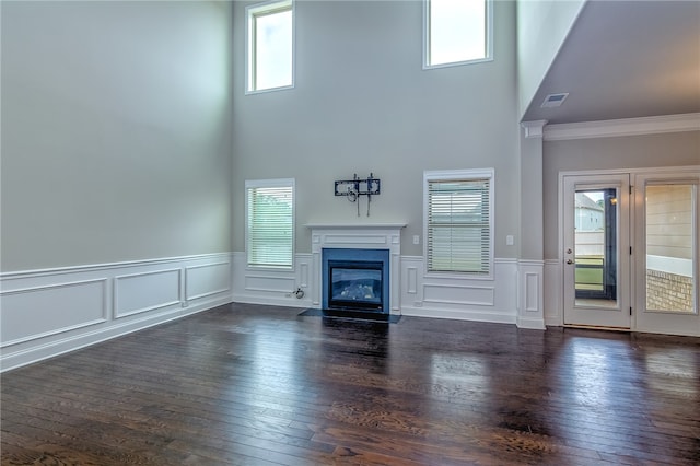 unfurnished living room featuring dark hardwood / wood-style floors and a wealth of natural light