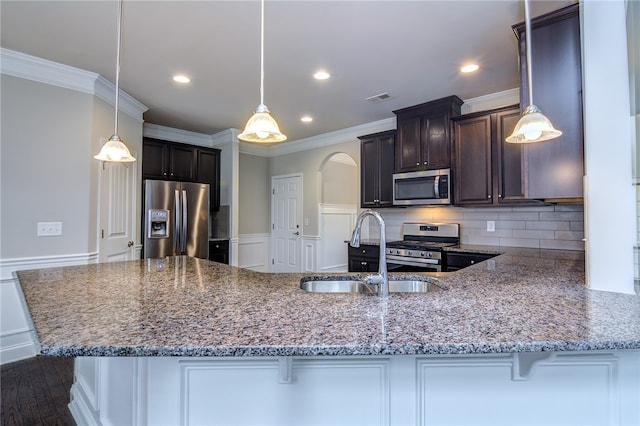 kitchen featuring stainless steel appliances, dark hardwood / wood-style floors, and hanging light fixtures