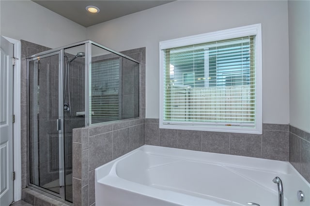 bathroom with shower with separate bathtub