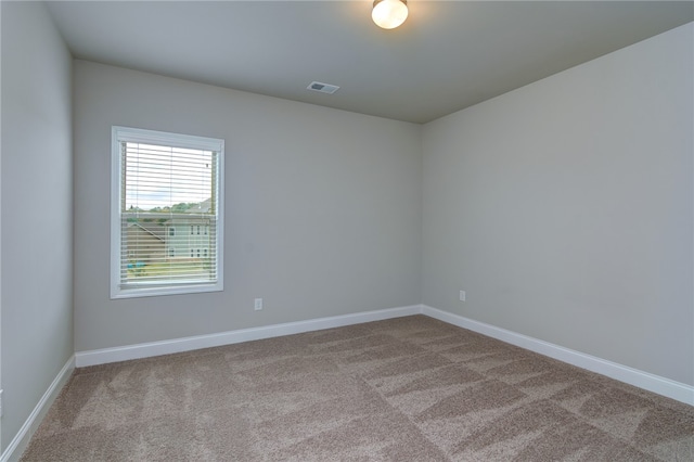 unfurnished room featuring light carpet