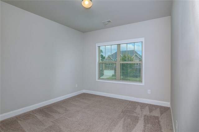 unfurnished room with light colored carpet