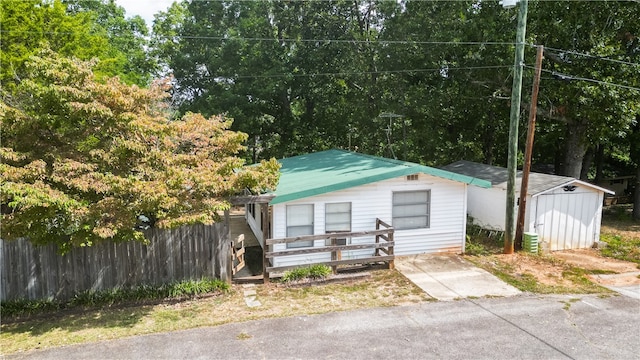 bungalow-style home featuring a storage unit