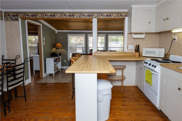 kitchen featuring white cabinets, white appliances, a breakfast bar area, dark hardwood / wood-style flooring, and wooden counters