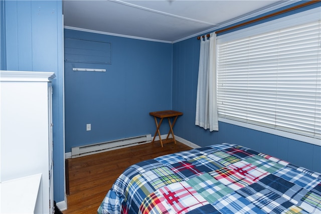 bedroom featuring dark hardwood / wood-style floors, wooden walls, ornamental molding, and baseboard heating