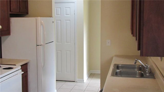 kitchen featuring sink and light tile patterned floors