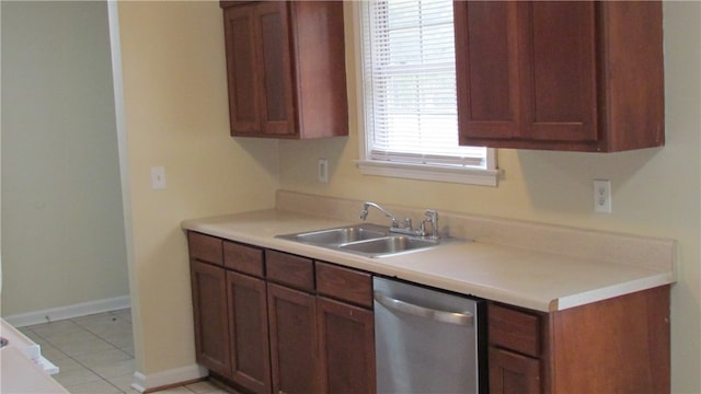 kitchen with dishwasher, light tile patterned floors, and sink