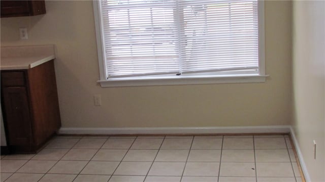 unfurnished dining area with light tile patterned floors