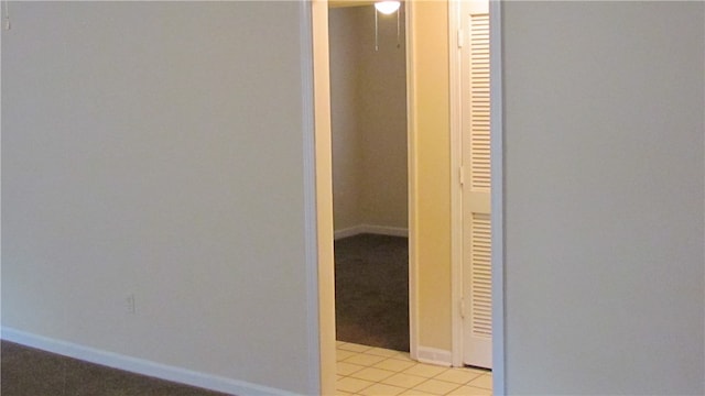 hall with light tile patterned floors