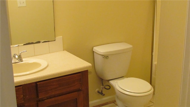 bathroom featuring tile patterned flooring, vanity, and toilet