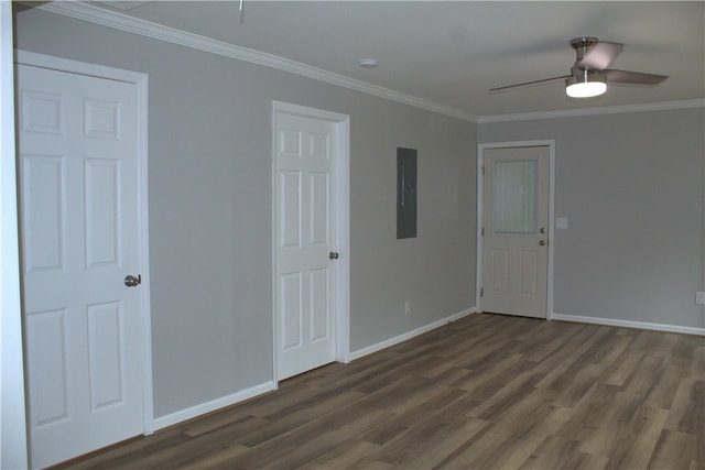 empty room featuring electric panel, ceiling fan, dark hardwood / wood-style flooring, and ornamental molding