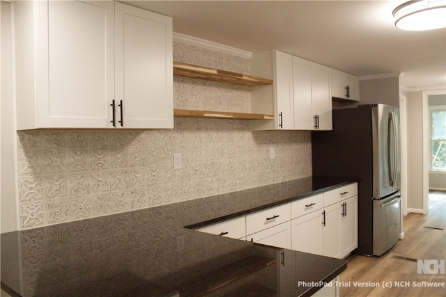 kitchen with light wood-type flooring, white cabinetry, and crown molding