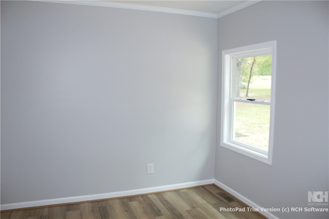 unfurnished room featuring hardwood / wood-style floors and crown molding