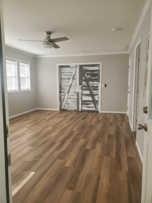 empty room featuring dark hardwood / wood-style floors, ceiling fan, and crown molding