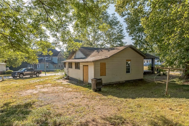 view of side of home with a lawn