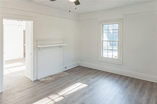 spare room featuring light hardwood / wood-style flooring and ceiling fan