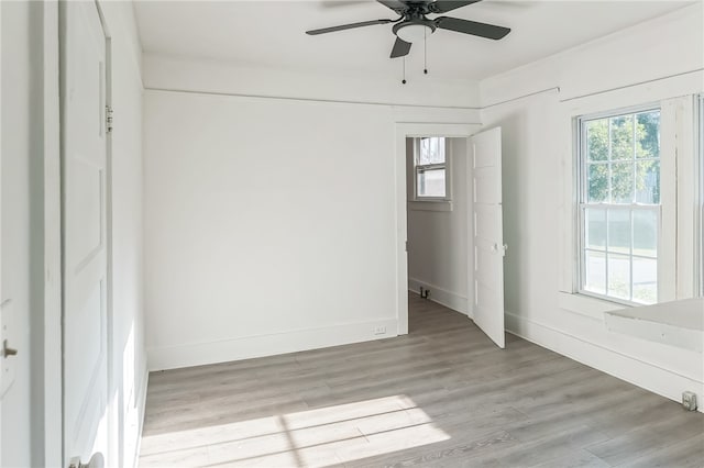 empty room with light hardwood / wood-style floors and ceiling fan