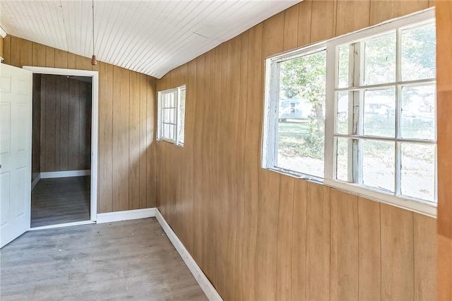 interior space featuring lofted ceiling, wood walls, hardwood / wood-style floors, and wooden ceiling