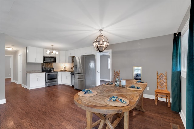 dining space with dark hardwood / wood-style flooring and a notable chandelier