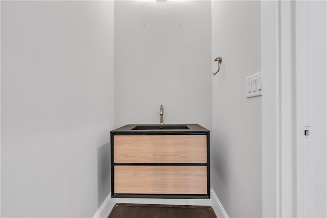 bathroom with wood-type flooring and sink